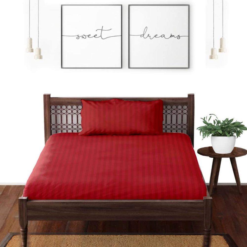 Satin striped pure cotton bedsheet in maroon on a double bed